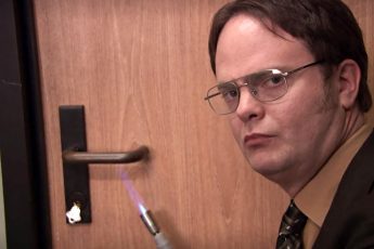 Dwight from The Office heating up a door handle with a torch