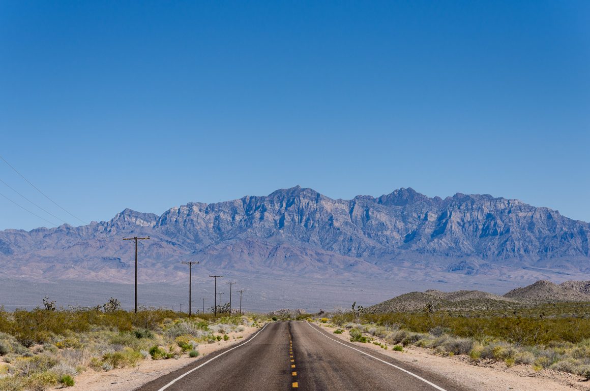 dessert road with mountains in the background