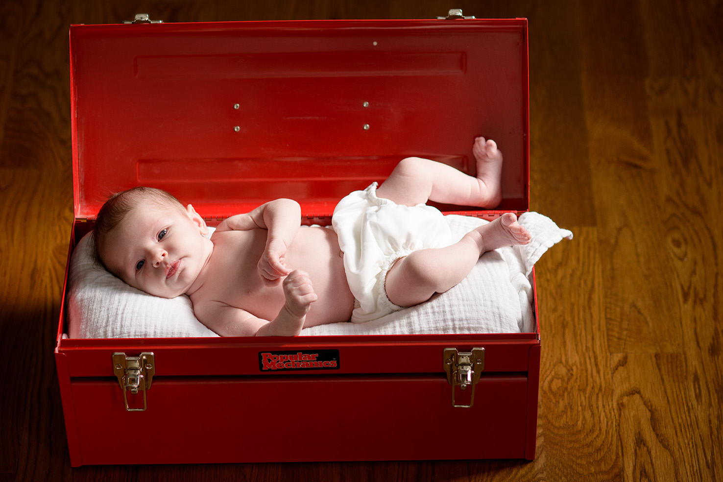 baby in red toolbox