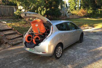 Nissan Leaf with a concrete mixer shoved in the back